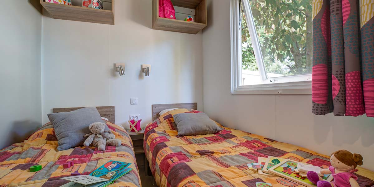 Room with two twin beds in the mobile home for rent at Le Fief campsite