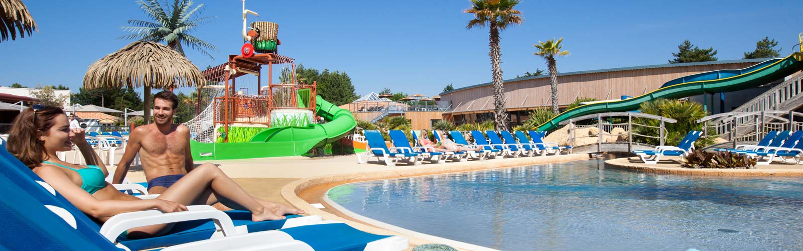 Deckchair and slide at the water park of the campsite Le Fief in Saint-Brevin