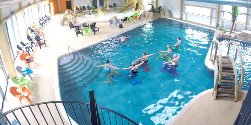 Plunging view of the heated indoor pool at Le Fief campsite